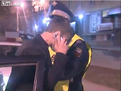Drunk Russian driver makes phone call with pack of cigarettes